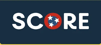 SCORE logo with the Tennessee state flag emblem replacing the letter O on a dark blue background.