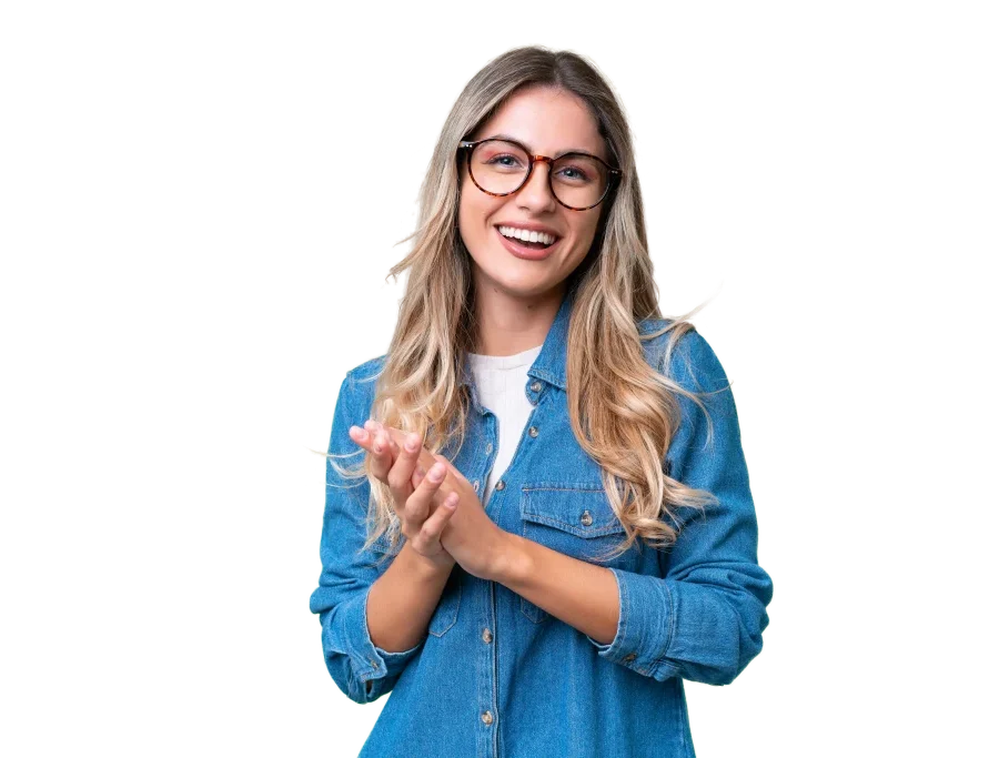 Happy blonde woman wearing glasses and a denim shirt claps her hands.